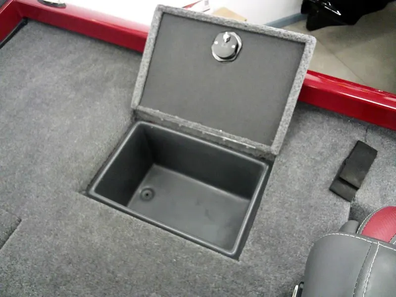 Slide: The Image of 2025 Ranger RT188C boat storage compartment with open lid, featuring gray carpeted interior. - 22