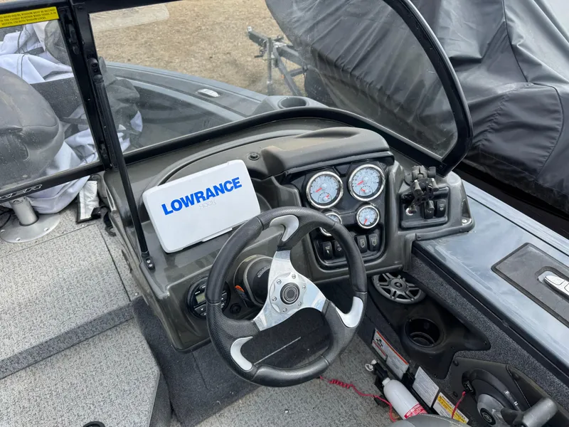 Slide: The Image of 2021 Tracker Targa V-18 Combo boat dashboard with Lowrance display and steering wheel. - 10