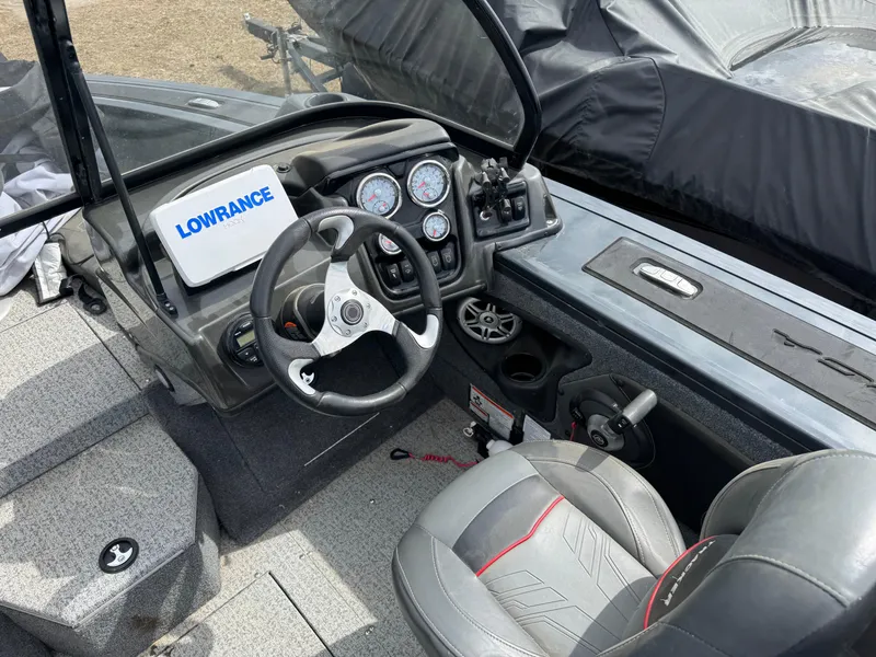 Slide: The Image of 2021 Tracker Targa V-18 Combo boat interior with steering wheel and Lowrance display. - 12