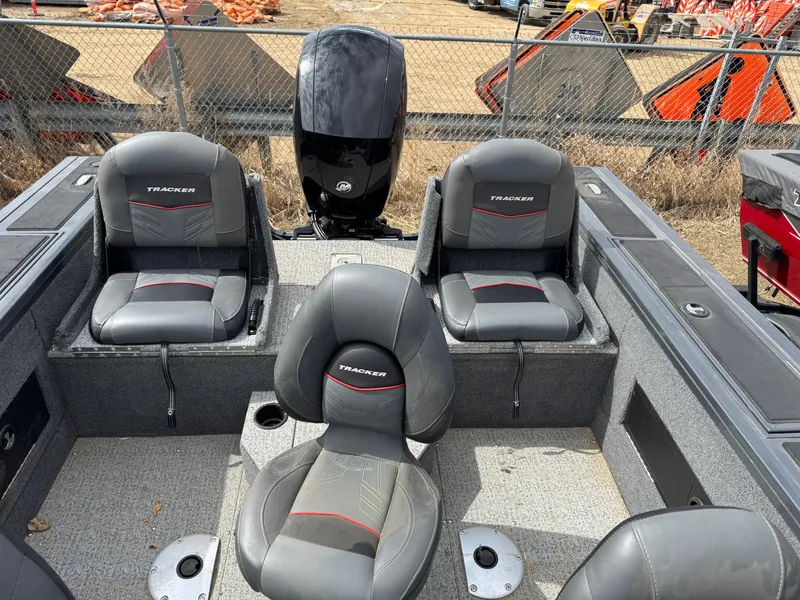 Slide: The Image of 2021 Tracker Targa V-18 Combo boat interior with four gray seats and an outboard motor. - 13