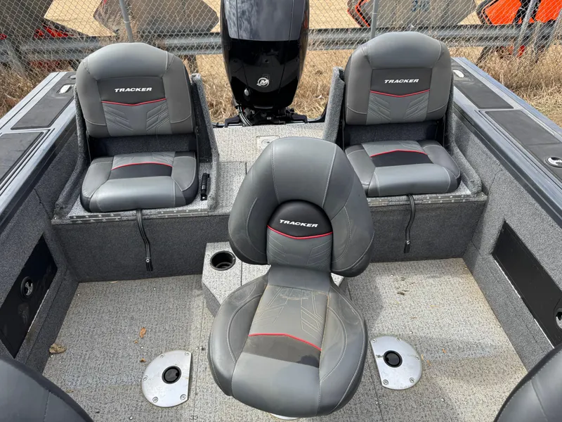 Slide: The Image of 2021 Tracker Targa V-18 Combo boat interior with gray seating and motor. - 8
