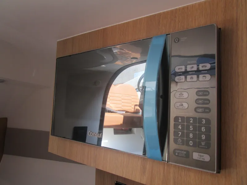 Slide: The Image of Microwave oven inside 2025 NX Boats 290, featuring a sleek, modern design. - 13