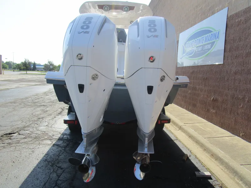 Slide: The Image of 2025 NX Boats 290 with dual 600 V6 engines at Grand Pointe Marina. - 4