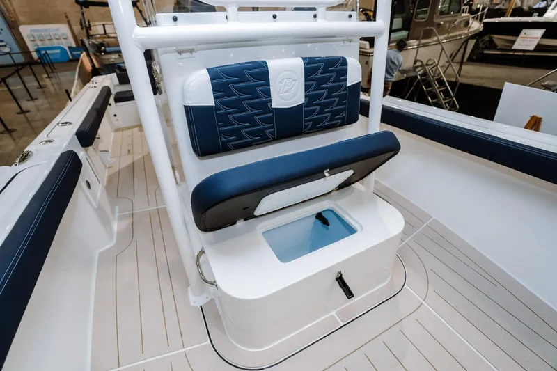 Slide: The Image of Parker 23 Special Edition 2025 boat interior with blue seating and storage compartment. - 12