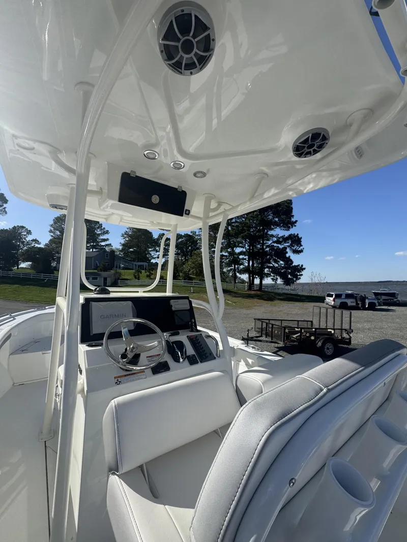 Slide: The Image of 2025 Parker 23 SE CC boat interior with modern helm and seating. - 4