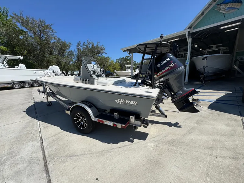 Slide: The Image of 2024 Hewes Redfisher 16 boat on trailer with Yamaha outboard motor. - 16