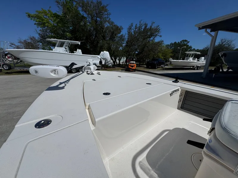 Slide: The Image of 2024 Hewes Redfisher 16 boat, white deck, parked outdoors, clear sky. - 18