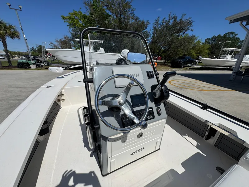 Slide: The Image of 2024 Hewes Redfisher 16 boat interior with steering console and controls. - 22