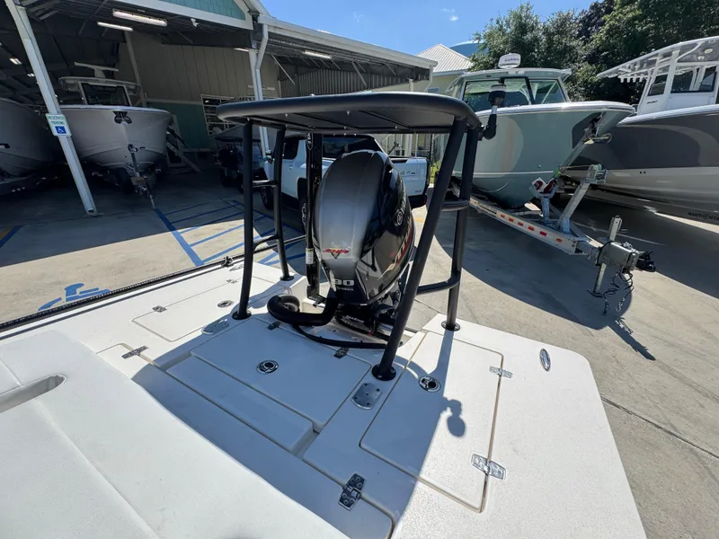 Slide: The Image of 2024 Hewes Redfisher 16 boat with outboard motor, parked in a marina. - 26