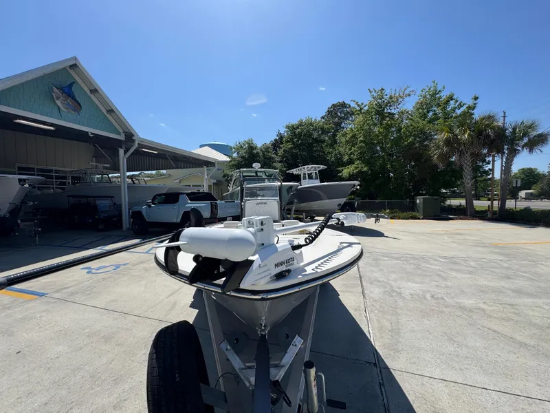 Slide: The Image of 2024 Hewes Redfisher 16 boat on trailer in sunny outdoor setting. - 5