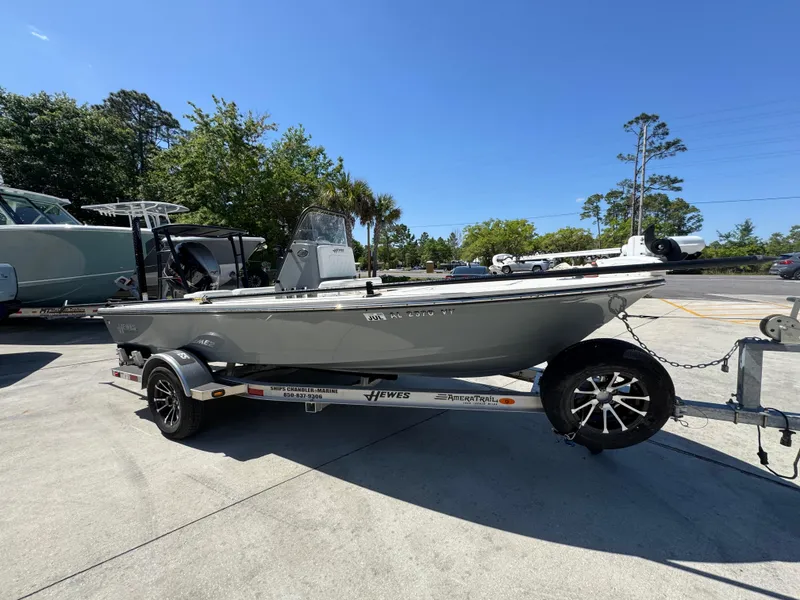 Slide: The Image of 2024 Hewes Redfisher 16 boat on trailer, parked outdoors under clear sky. - 7