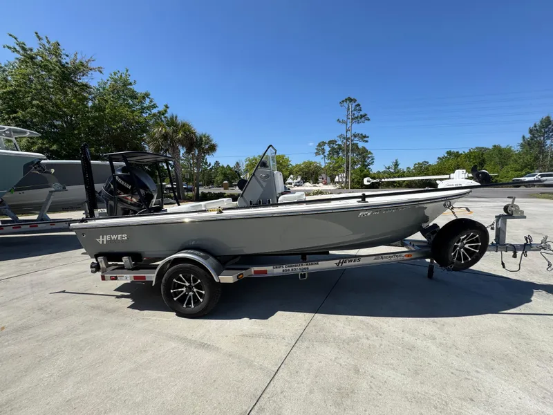 Slide: The Image of 2024 Hewes Redfisher 16 boat on trailer, parked outdoors under clear sky. - 8