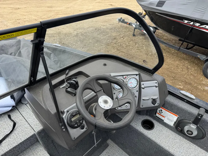 Slide: The Image of 2023 Tracker Pro Guide V-175 WT boat dashboard with steering wheel and controls. - 10