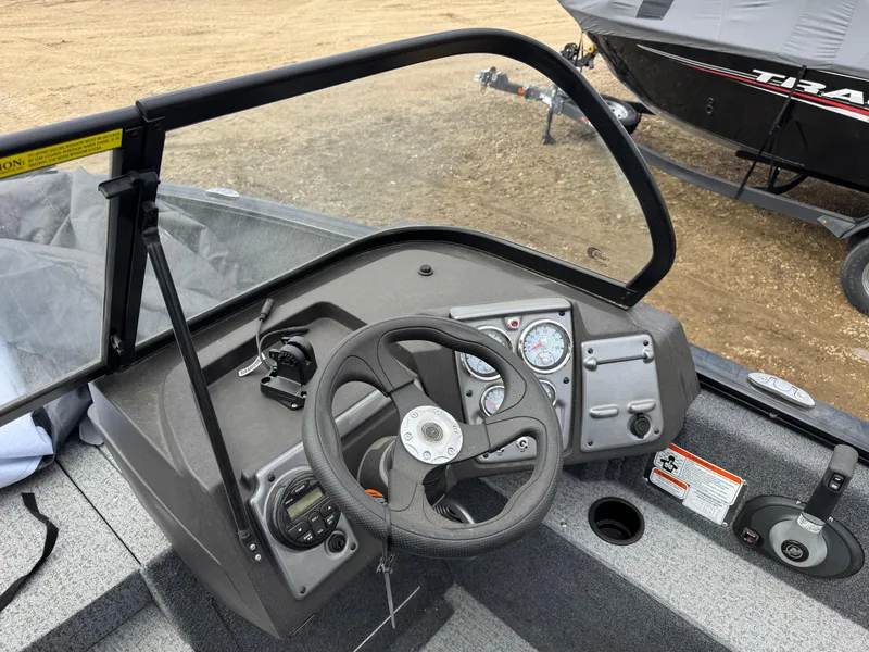 Slide: The Image of 2023 Tracker Pro Guide V-175 WT boat dashboard with steering wheel and controls. - 11