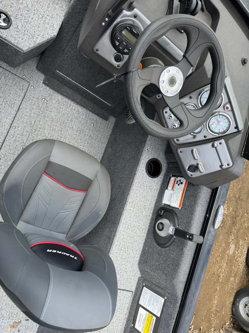 Slide: The Image of 2023 Tracker Pro Guide V-175 WT boat interior with steering wheel and seat. - 12
