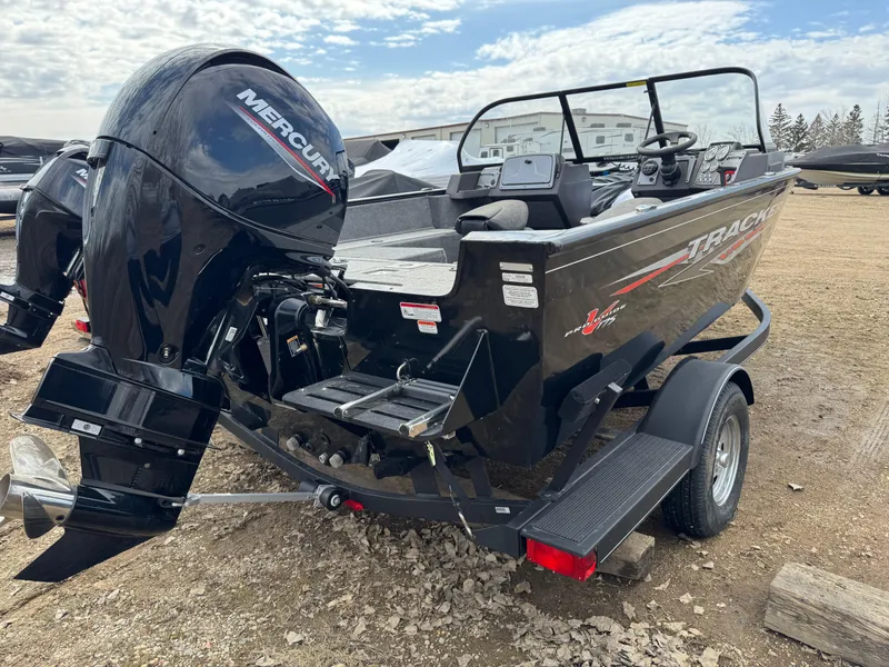 Slide: The Image of 2023 Tracker Pro Guide V-175 WT boat with Mercury outboard motor on a trailer. - 2