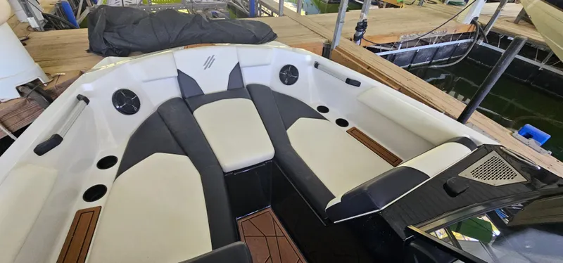 Slide: The Image of 2020 ATX Surf Boats 24 Type-S interior with cushioned seating and cup holders. - 19