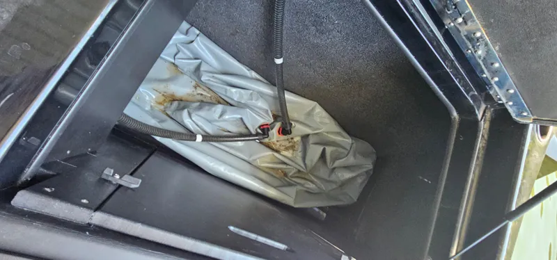 Slide: The Image of 2020 ATX Surf Boats 24 Type-S ballast compartment with gray bag and hoses. - 28