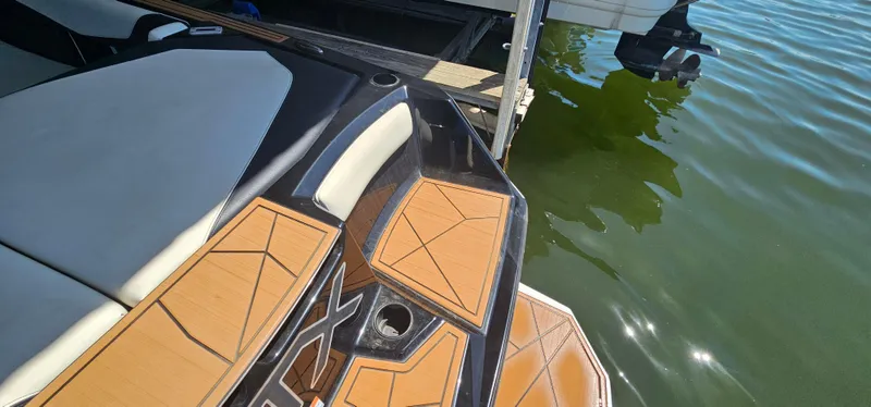 Slide: The Image of 2020 ATX Surf Boats 24 Type-S at dock, featuring sleek design and teak-style decking. - 30