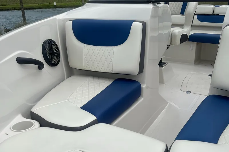 Slide: The Image of Interior of a 2016 Tahoe TAH450TS boat with blue and white seating. - 4