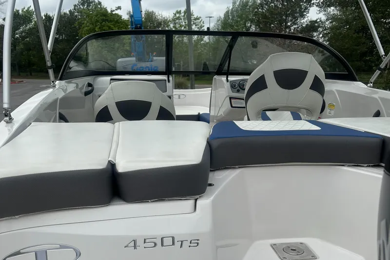 Slide: The Image of 2016 Tahoe TAH450TS boat interior with cushioned seating and steering console. - 5