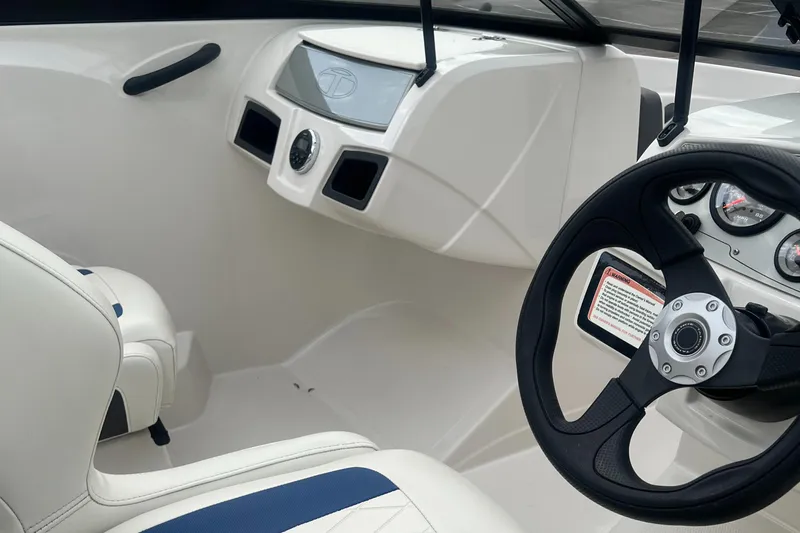 Slide: The Image of Interior of a 2016 Tahoe TAH450TS boat, featuring steering wheel and dashboard controls. - 6