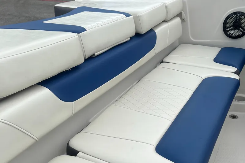 Slide: The Image of 2016 Tahoe TAH450TS boat interior with blue and white cushioned seating. - 7