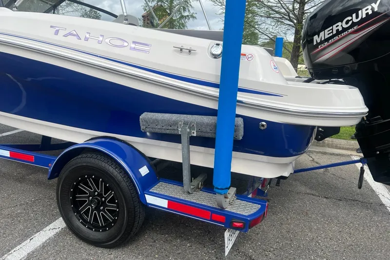 Slide: The Image of 2016 Tahoe TAH450TS boat on trailer with Mercury outboard motor. - 8