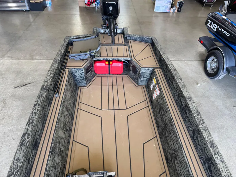 Slide: The Image of 2025 Tracker Grizzly 1650 T Prairie Wings Edition boat interior with camouflage design. - 12
