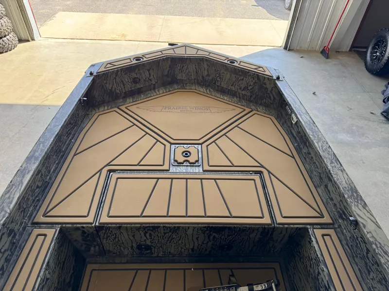 Slide: The Image of 2025 Tracker Grizzly 1650 T Prairie Wings Edition boat interior with custom flooring. - 13