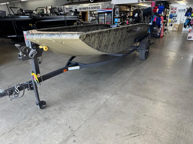 Slide: The Image of 2025 Tracker Grizzly 1650 T Prairie Wings Edition boat on trailer in showroom. - 4