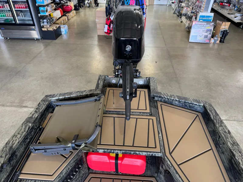 Slide: The Image of 2025 Tracker Grizzly 1650 T Prairie Wings Edition boat interior with motor and storage compartments. - 9