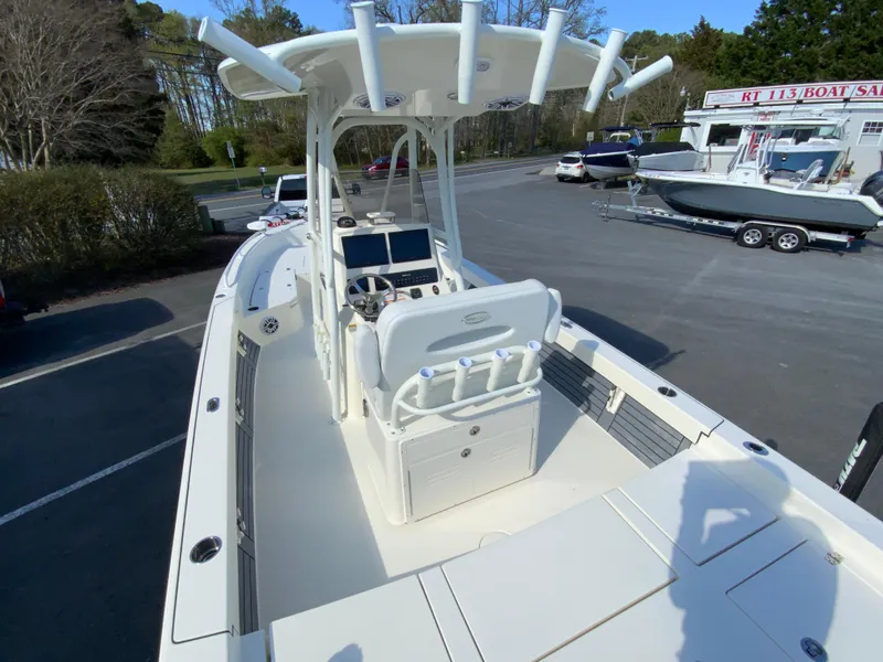 Slide: The Image of 2025 Pathfinder 2600 TRS boat at a dealership, featuring a spacious deck and modern console. - 10