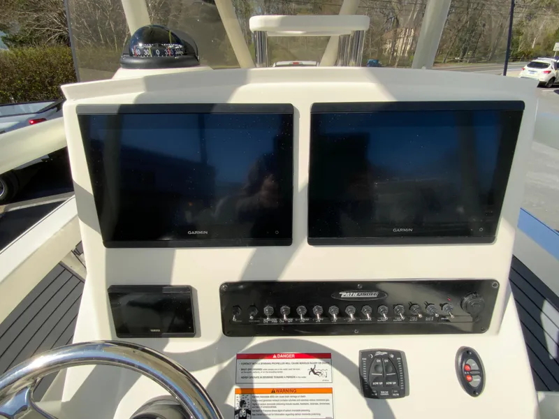 Slide: The Image of 2025 Pathfinder 2600 TRS boat dashboard with dual Garmin displays and control panel. - 12