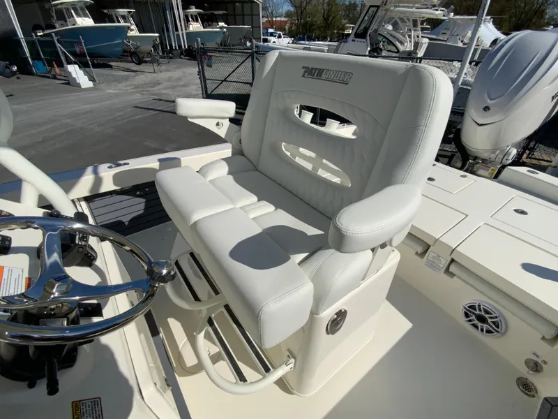 Slide: The Image of 2025 Pathfinder 2600 TRS boat seat with steering wheel, docked in marina. - 14