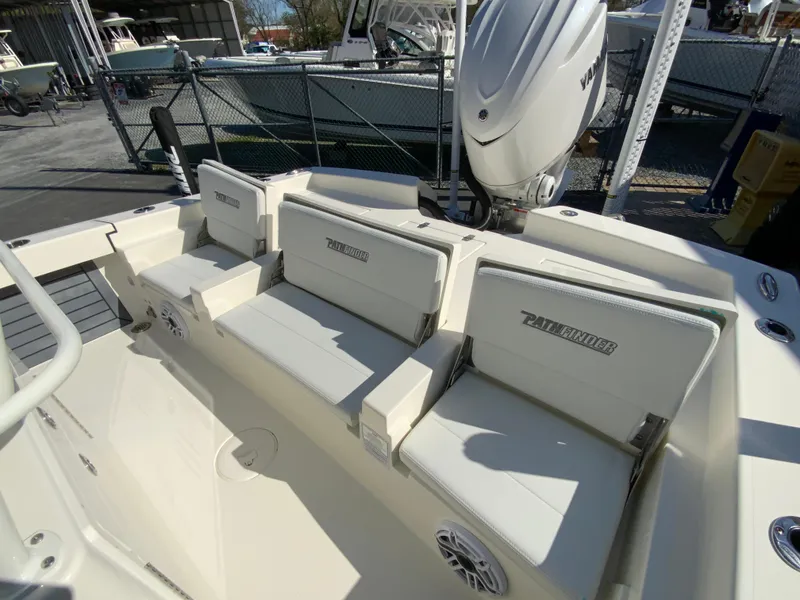 Slide: The Image of 2025 Pathfinder 2600 TRS boat interior with cushioned seating and Yamaha outboard motor. - 16