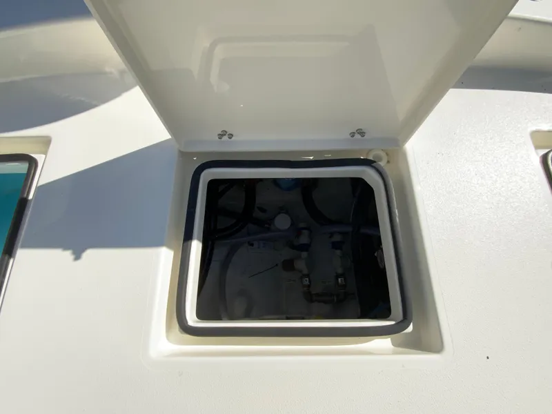 Slide: The Image of Open hatch on 2025 Pathfinder 2600 TRS boat deck, revealing internal compartment. - 20