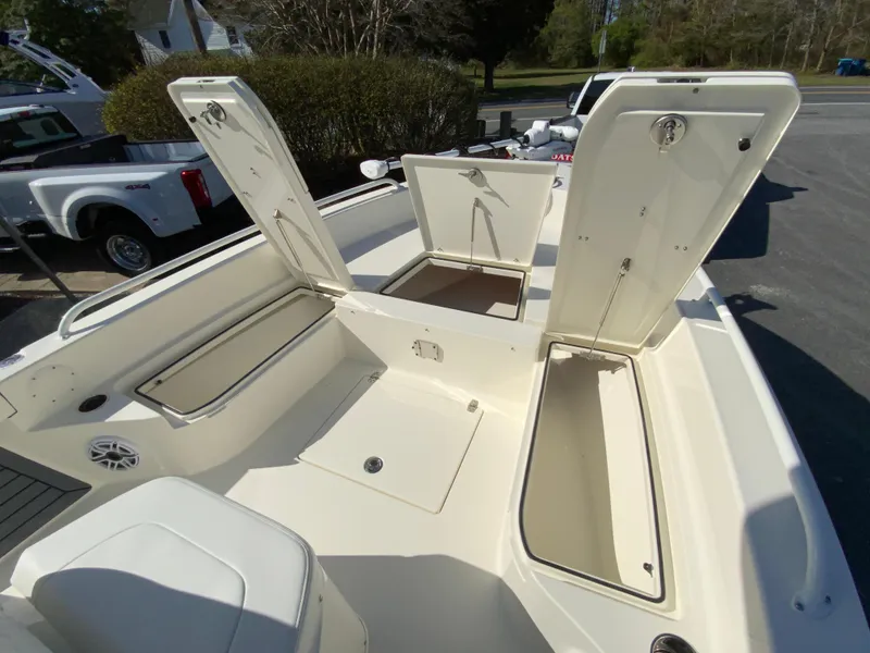 Slide: The Image of 2025 Pathfinder 2600 TRS boat with open storage compartments and seating area. - 23
