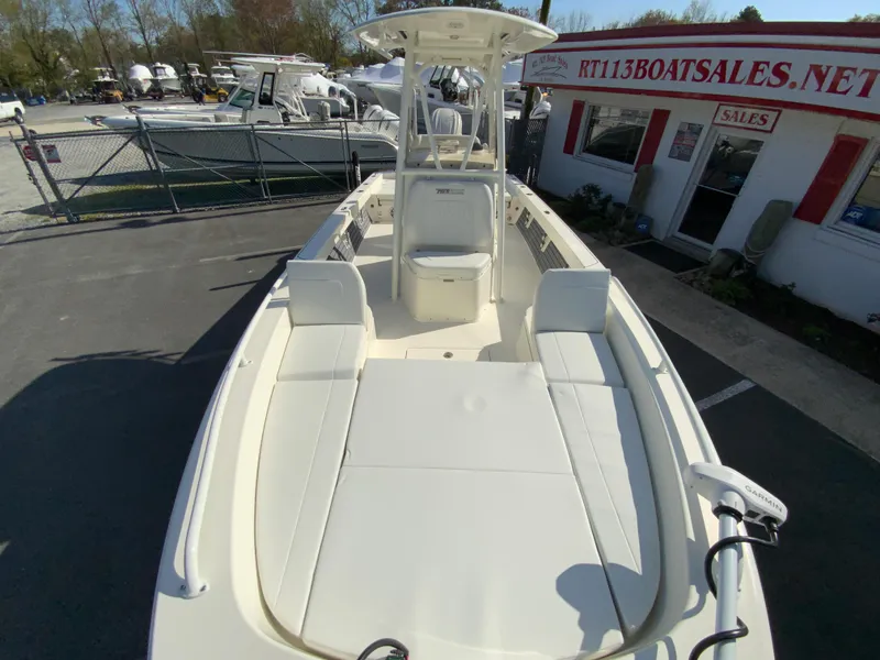 Slide: The Image of 2025 Pathfinder 2600 TRS boat displayed at dealership, featuring spacious deck and modern design. - 28