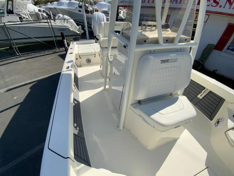 Slide: The Image of 2025 Pathfinder 2600 TRS boat interior with seating and console, docked outdoors. - 31