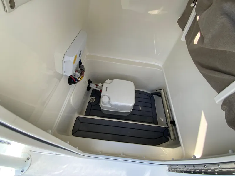 Slide: The Image of 2025 Pathfinder 2600 TRS boat interior with compact marine toilet setup. - 33