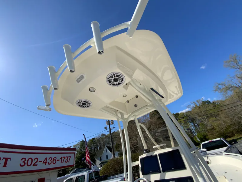 Slide: The Image of 2025 Pathfinder 2600 TRS boat with T-top and rod holders under clear blue sky. - 35