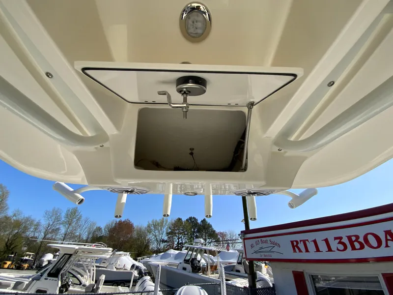 Slide: The Image of 2025 Pathfinder 2600 TRS boat underside view with rod holders and storage compartment. - 37