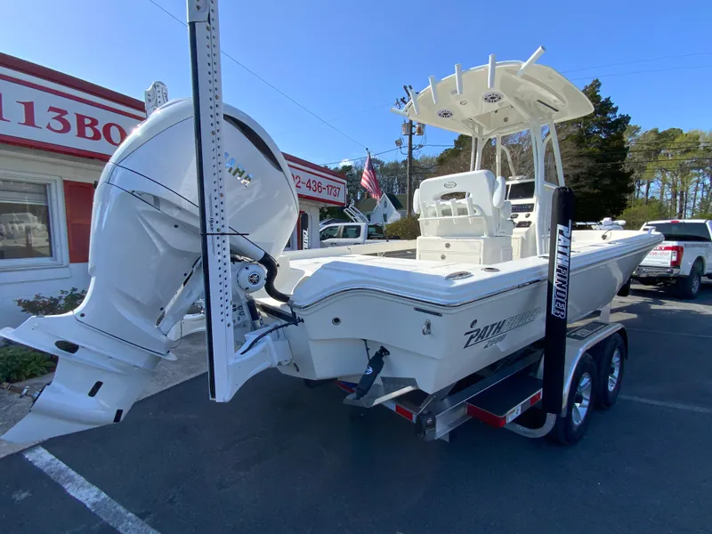Slide: The Image of 2025 Pathfinder 2600 TRS boat on trailer, parked outdoors near a building. - 9