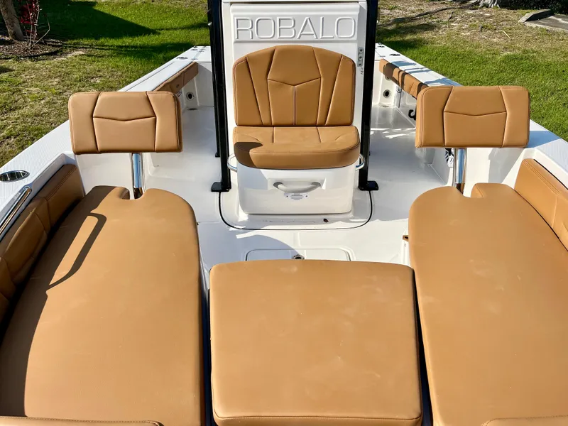 Slide: The Image of 2025 Robalo 226 Cayman boat interior with tan seating and sleek design. - 12