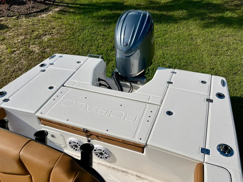 Slide: The Image of 2025 Robalo 226 Cayman boat with outboard motor, featuring spacious deck and seating. - 14