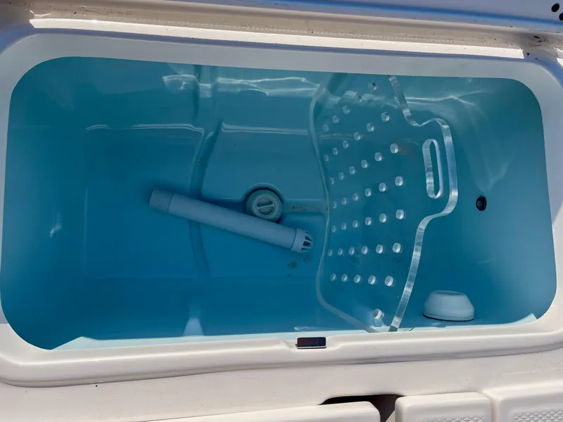 Slide: The Image of Livewell in 2025 Robalo 226 Cayman boat, featuring a blue interior and aeration system. - 16