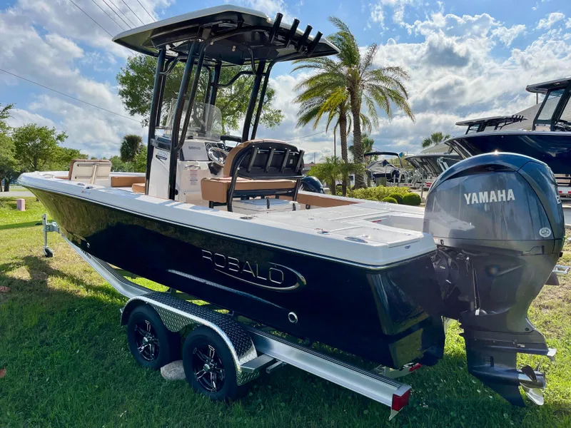 Slide: The Image of 2025 Robalo 226 Cayman boat with Yamaha engine on a trailer, parked on grass. - 6