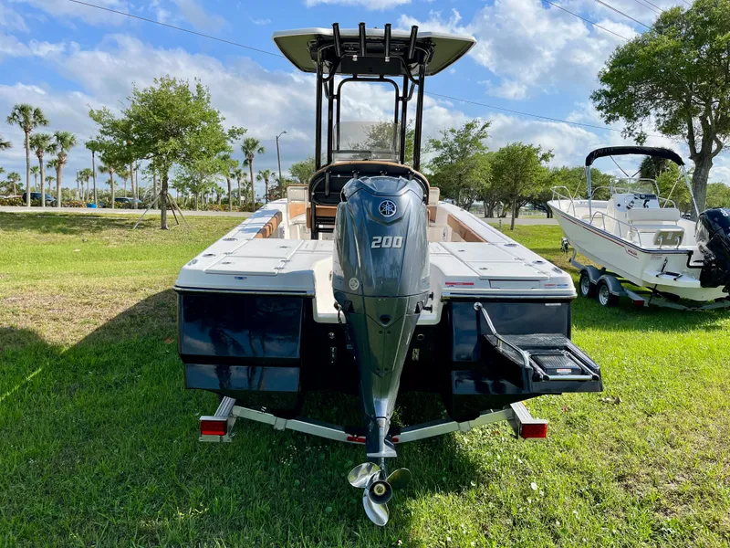 Slide: The Image of 2025 Robalo 226 Cayman boat with Yamaha 200 engine, parked on grass. - 7
