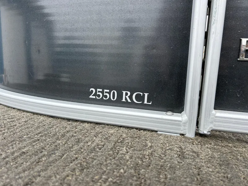 Slide: The Image of 2014 Bennington 2550 RCL boat model detail on metallic surface. - 14